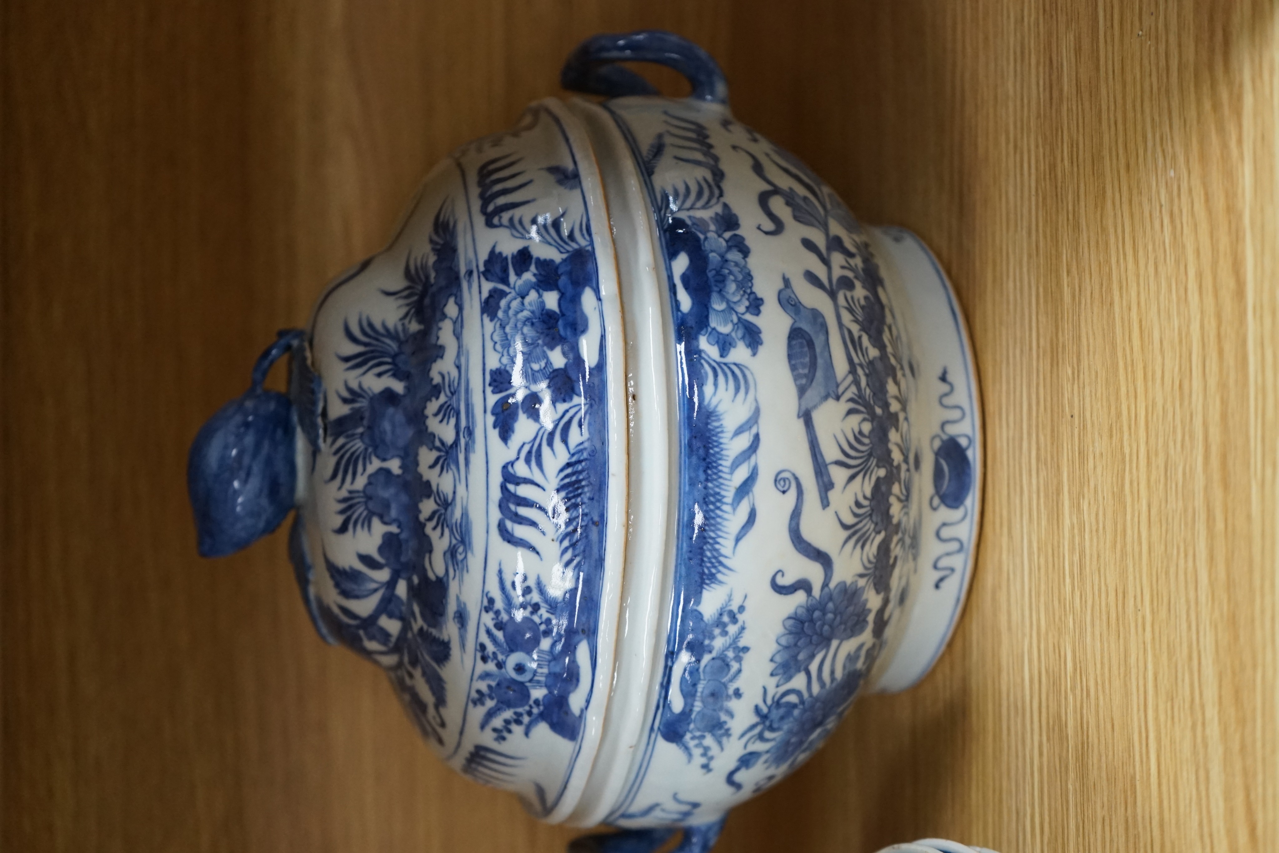 An 18th century Chinese Export blue and white octagonal tureen and cover, decorated with birds and flowers, a pair of similar sauceboats and five plates decorated with urns of flowers